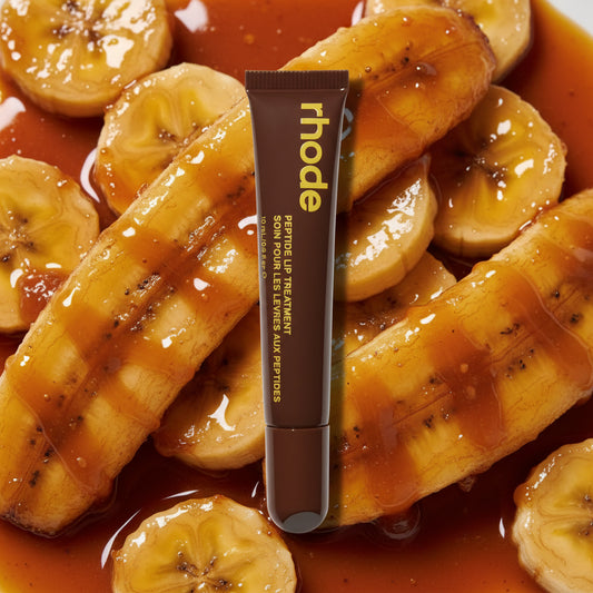 Brown lip balm tube with 'rhode' branding on a white background